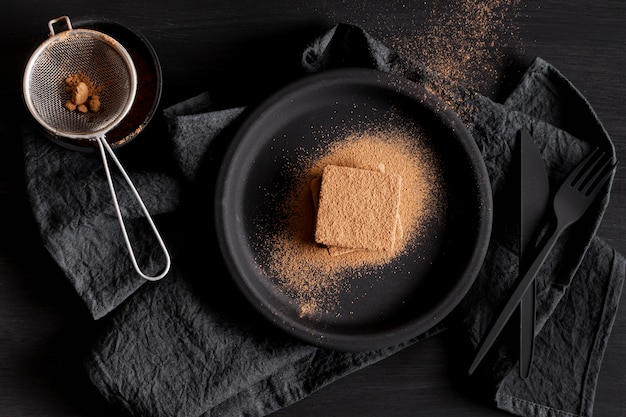 Flat lay chocolate powder and sieve