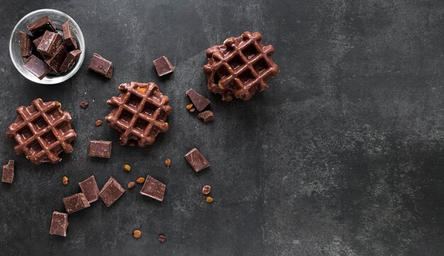 Flat lay of chocolate waffles with copy space