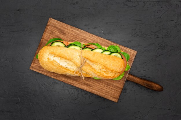 Flat lay of chopping board with sandwich on top