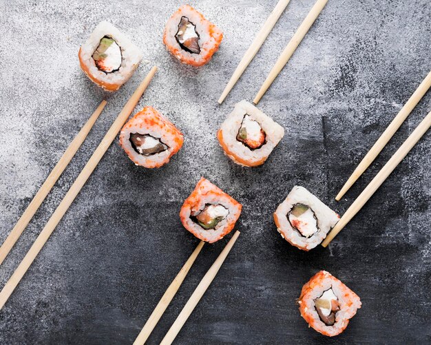 Flat lay chopsticks and delicious sushi