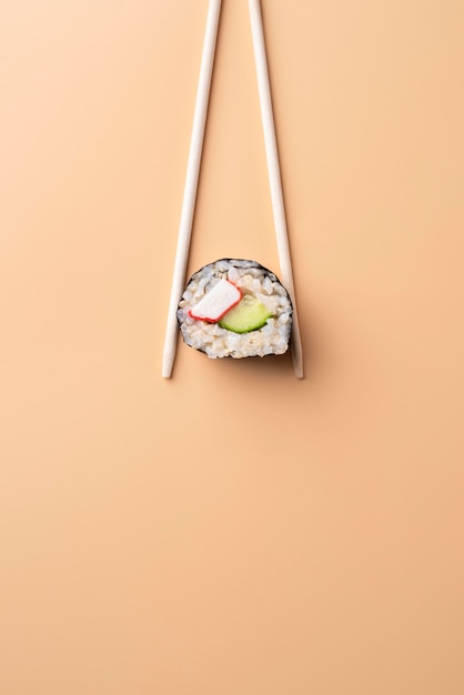 Free photo flat lay chopsticks holding sushi