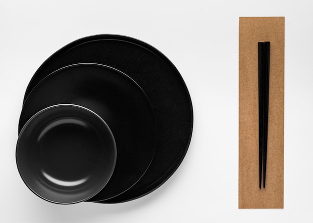 Free photo flat lay of chopsticks with dinnerware