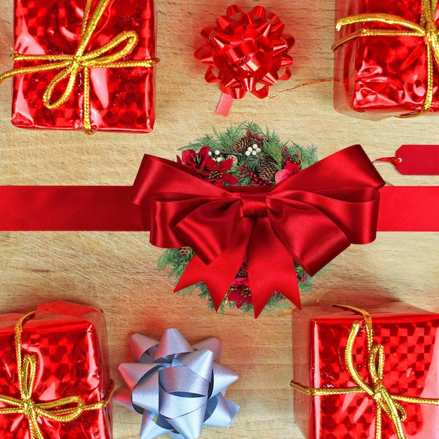 Flat lay of Christmas ornaments and gift boxes on a wooden table