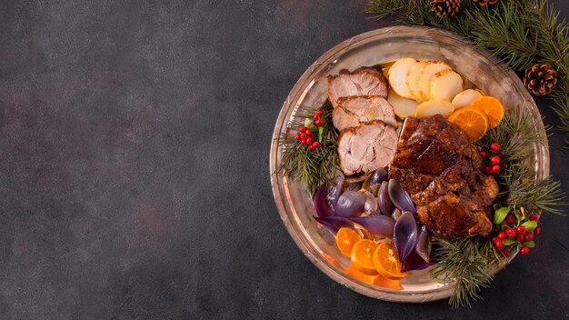 Flat lay of christmas steak on plate with pine cones decor and copy space