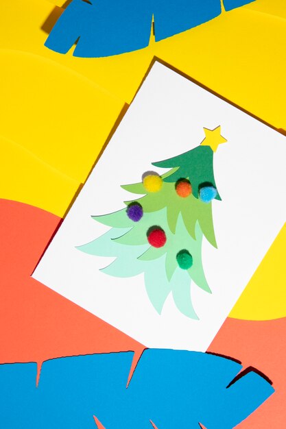 Flat lay christmas tree and tropical leaves