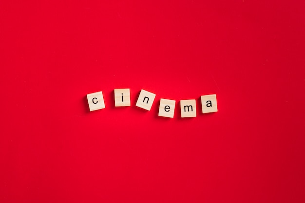 Flat lay cinema lettering on red background