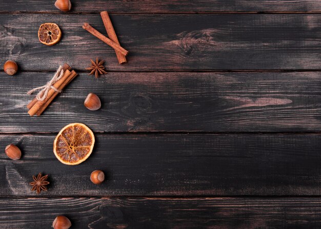 Flat lay of cinnamon sticks with chestnuts