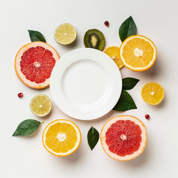 Flat lay of citrus with plate