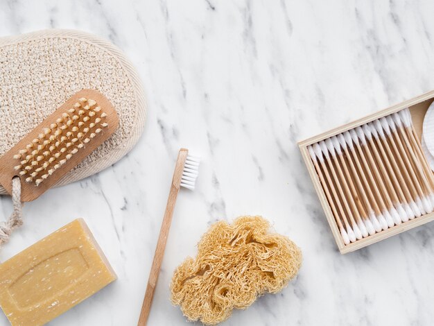 Flat lay cleaning products on marble table 