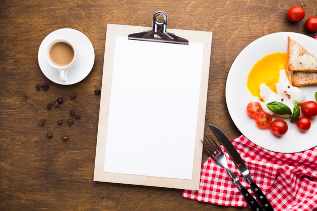 Flat lay clipboard mockup on breakfast table