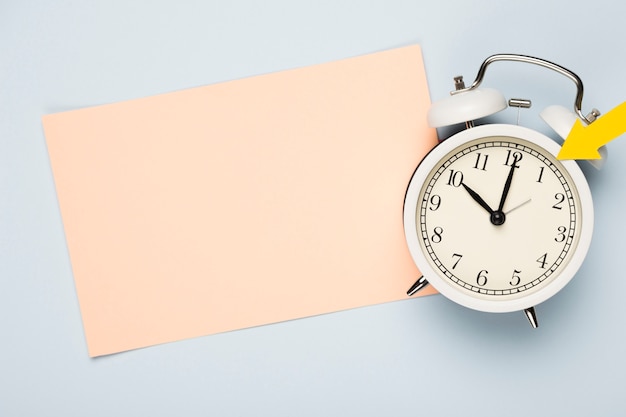 Flat lay clock with greeting card