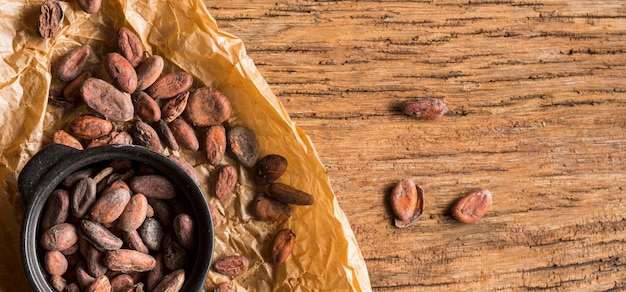 Free photo flat lay cocoa beans in pot