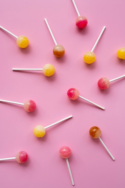 Free photo flat lay colorful ball lollipops