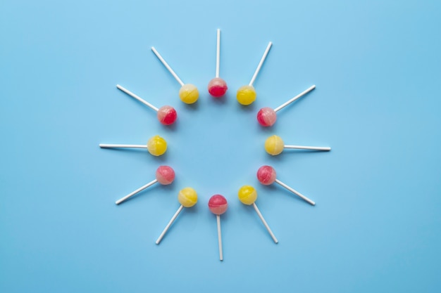 Free photo flat lay colorful ball lollipops