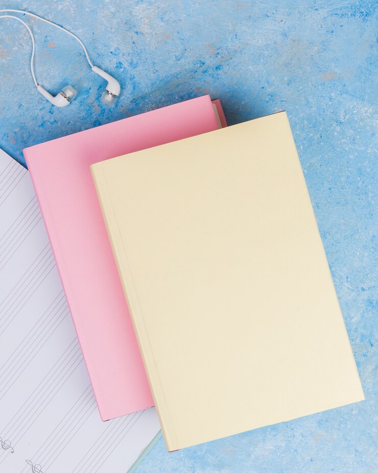 Free Photo flat lay of colorful book on plain background