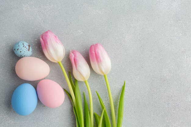 Flat lay of colorful easter eggs with tulips