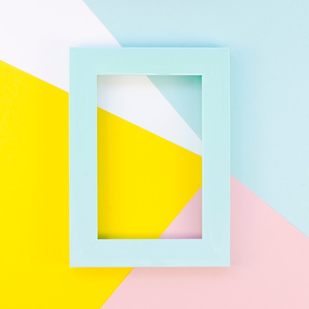 Flat lay of colorful frame on paper shapes