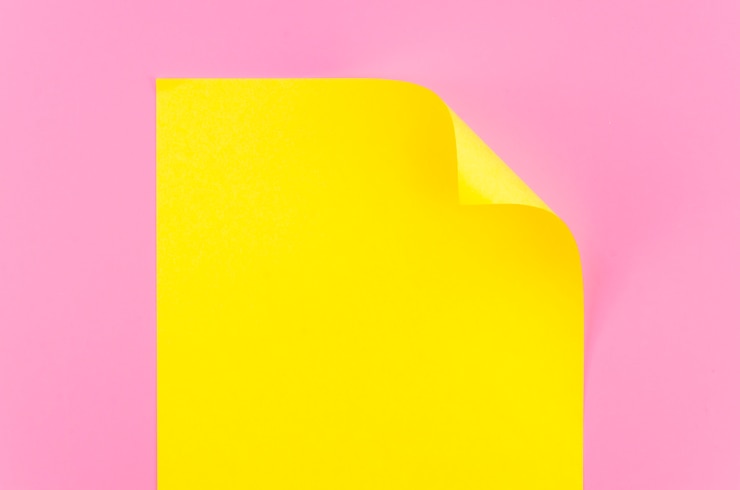 Free Photo flat lay of colorful paper sheet with bent corner