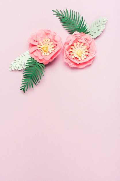 Flat lay of colorful paper spring flowers with leaves