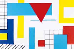 Foto gratuita lay piatto di triangoli e forme di carta colorata