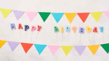 Free photo flat lay colorful party decorations on stucco background