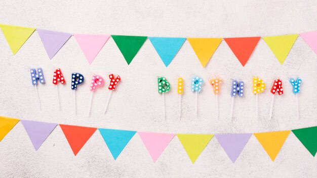 Flat lay colorful party decorations on stucco background