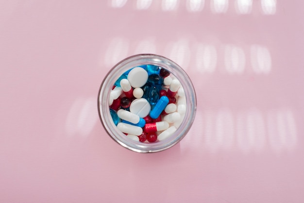 Free photo flat lay colorful pills in jar