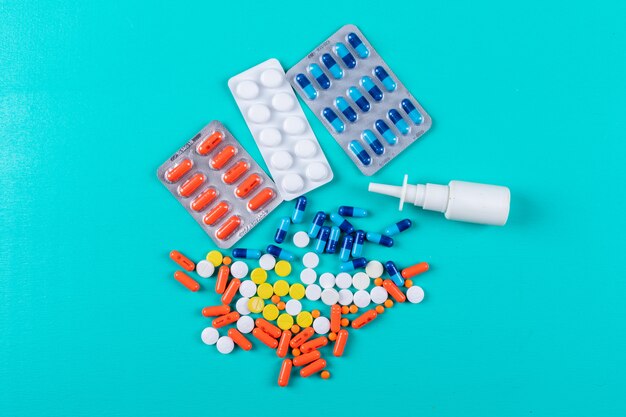 Flat lay colorful pills with nasal spray