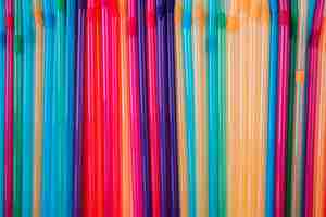 Free photo flat lay colorful plastic straws