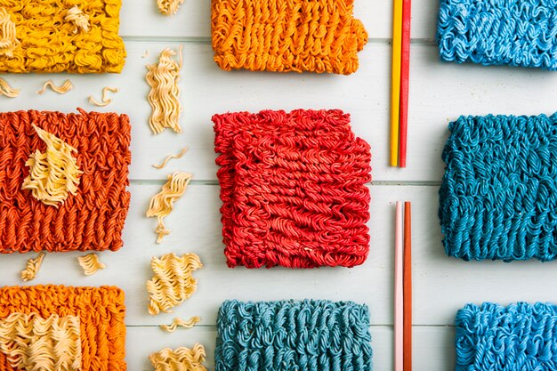 Flat lay colorful ramen noodles and colorful chopsticks