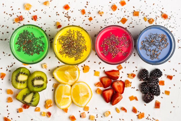 Flat lay colorful smoothies in glasses