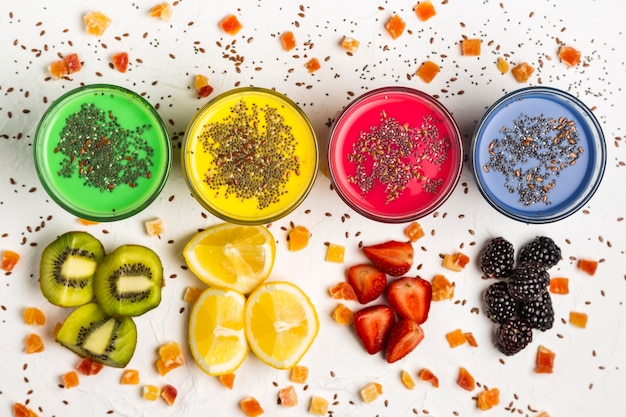 Flat lay colorful smoothies in glasses