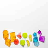 Free photo flat lay of colorful translucent shapes with copy space