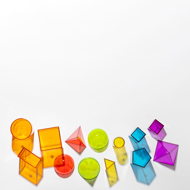 Flat lay of colorful translucent shapes with copy space