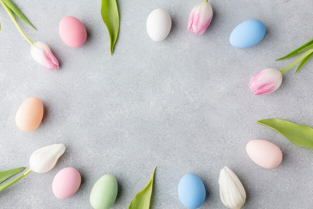 Flat lay of colorful tulips and easter eggs