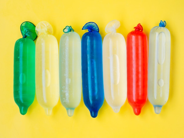 Flat lay colourful condoms filled with water