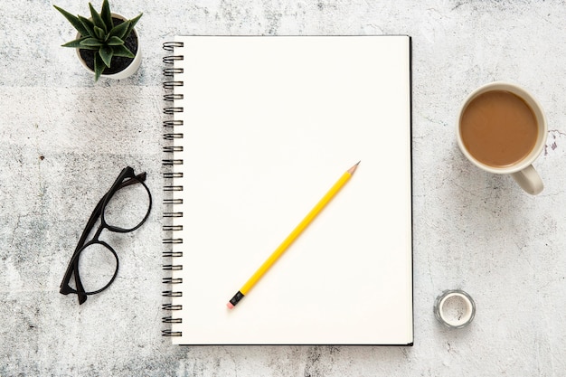 Flat lay composition of desk elements on cement background