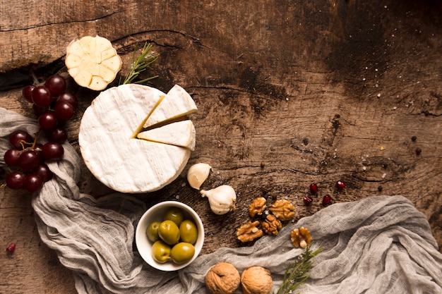 Flat lay composition of different delicacies on wooden table