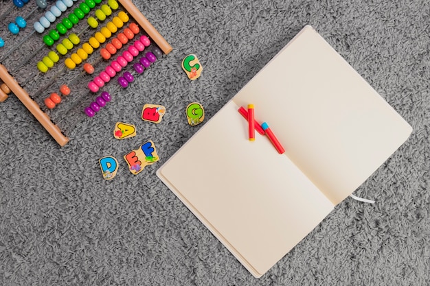 Flat lay composition of toys and open book template