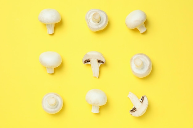 Flat lay composition with champignons on yellow background Free Photo
