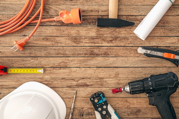 Free photo flat lay composition with different construction tools on wooden background