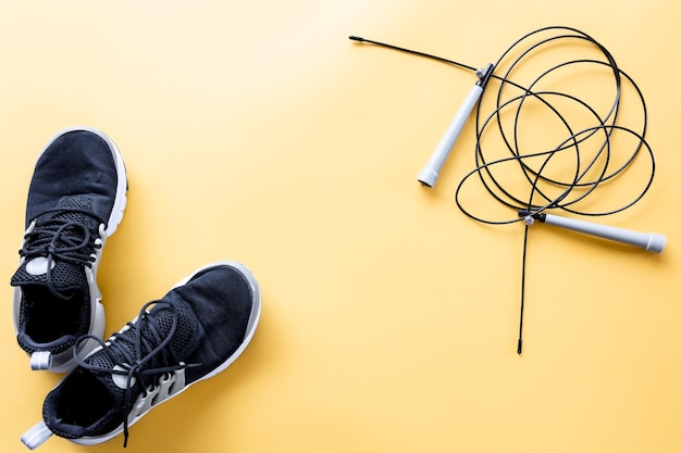 Flat lay composition with sports equipment on yellow background