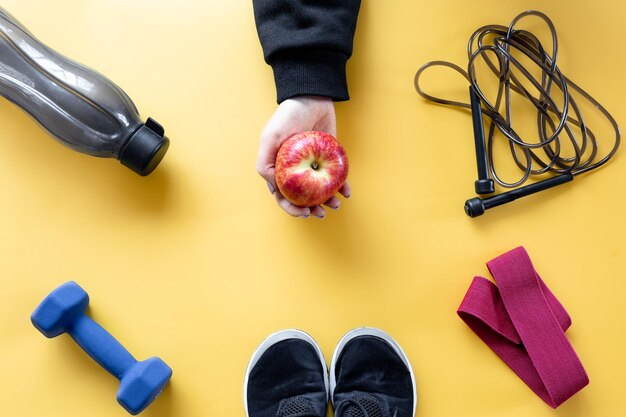 Flat lay composition with sports equipment on yellow background