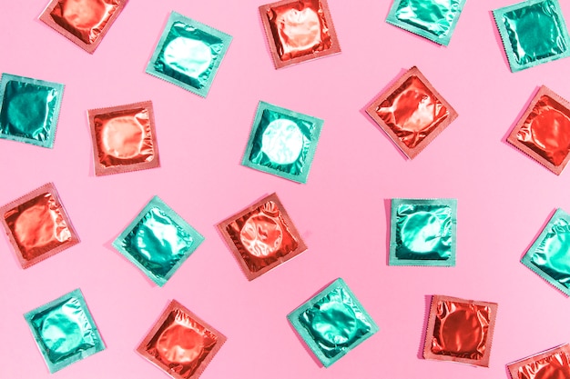 Flat lay condoms in red and green wrappers