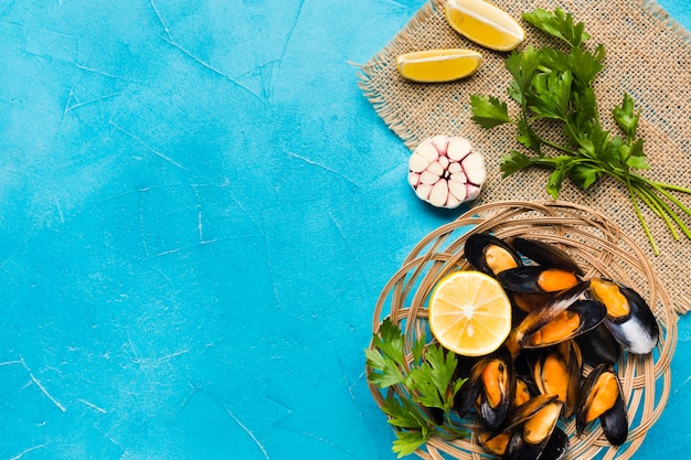 Flat-lay cooked mussels basket with copyspace