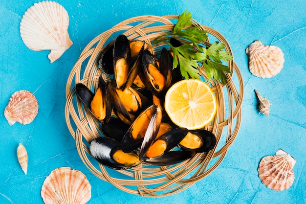 Flat-lay cooked mussels in basket