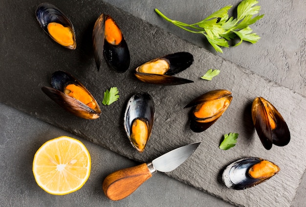 Flat-lay cooked mussels on slate