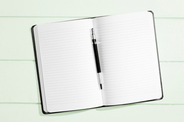 Flat lay copy space notebook with pen