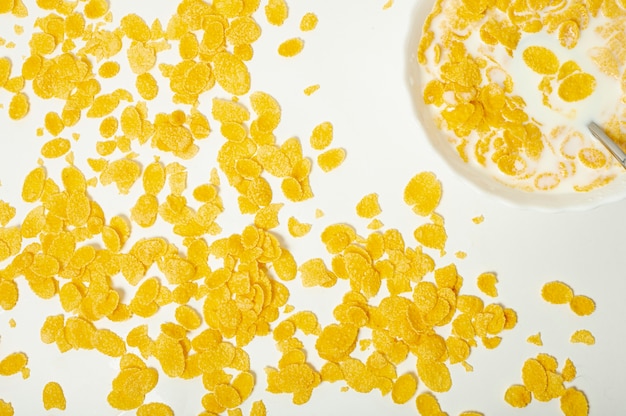 Flat lay cornflakes with milk arrangement  on plain background