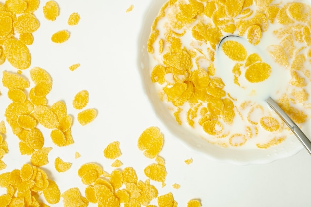 Foto gratuita fiocchi di mais piatto laici con latte su sfondo chiaro